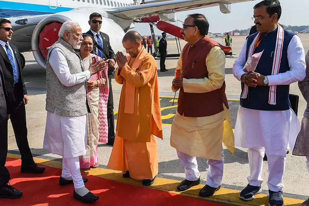 PM Modi arrives in Varanasi and is greeted by Governor Anandiben and Chief Minister Yogi Adityanath.